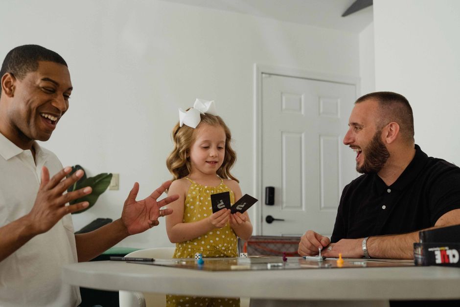A joyful moment with diverse family playing a card game at home.